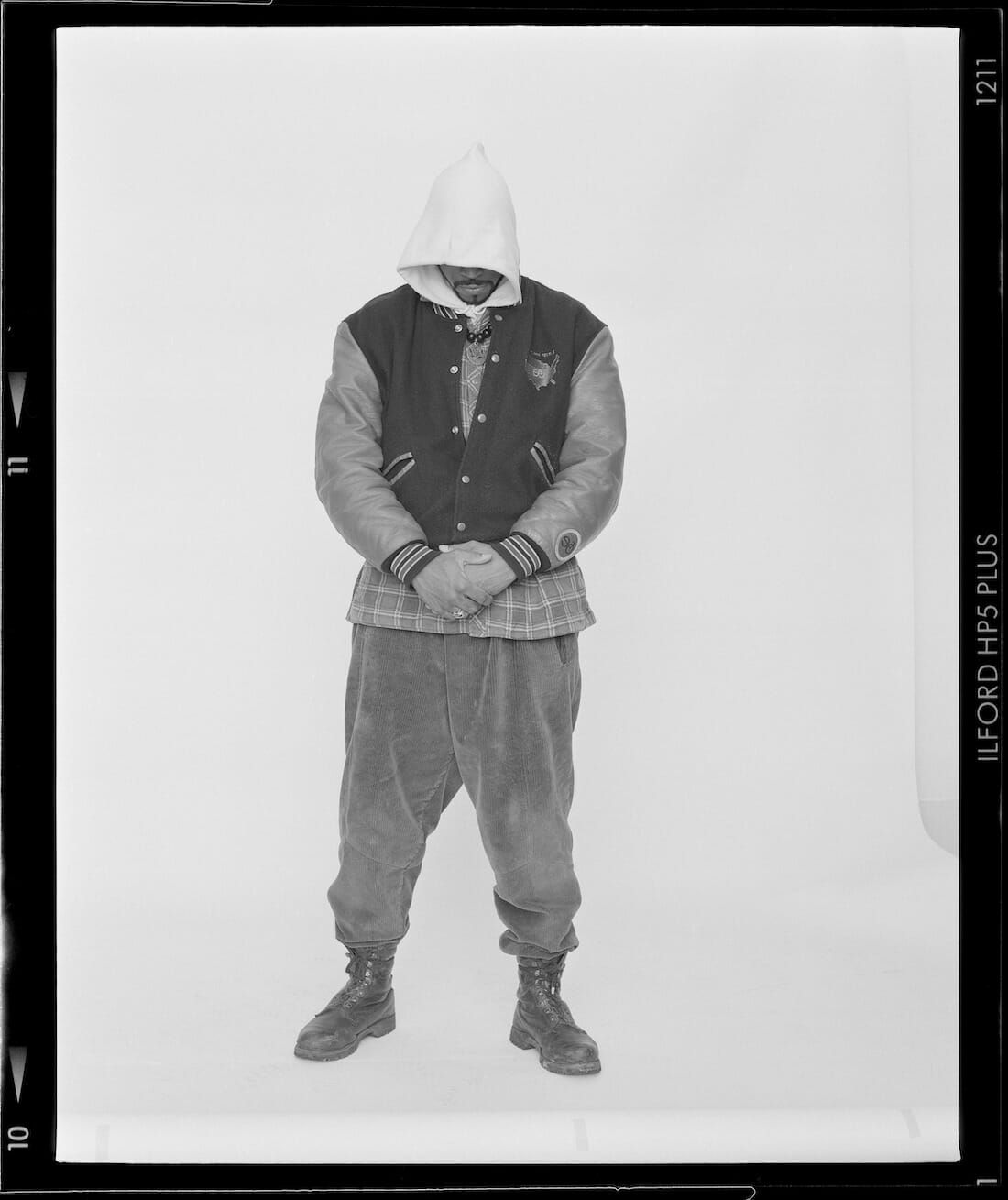 photograph artwork of a person posing, face concealed