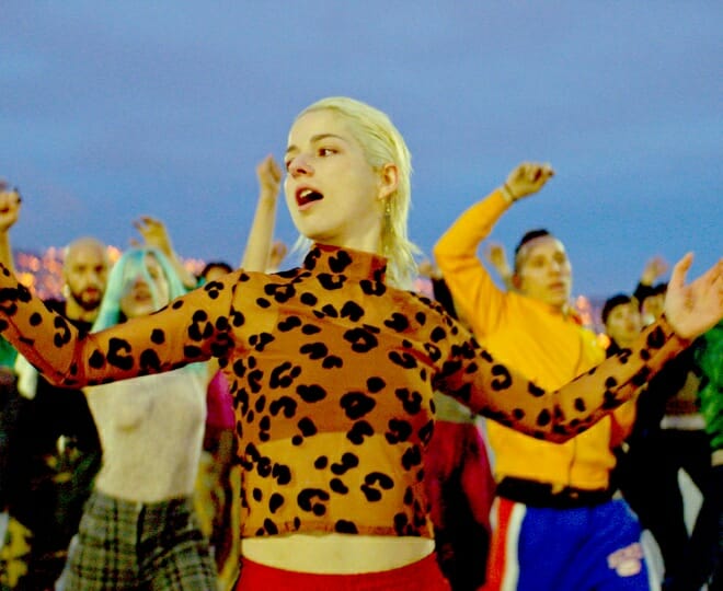 film still from "Ema" showing a group of people dancing and singing