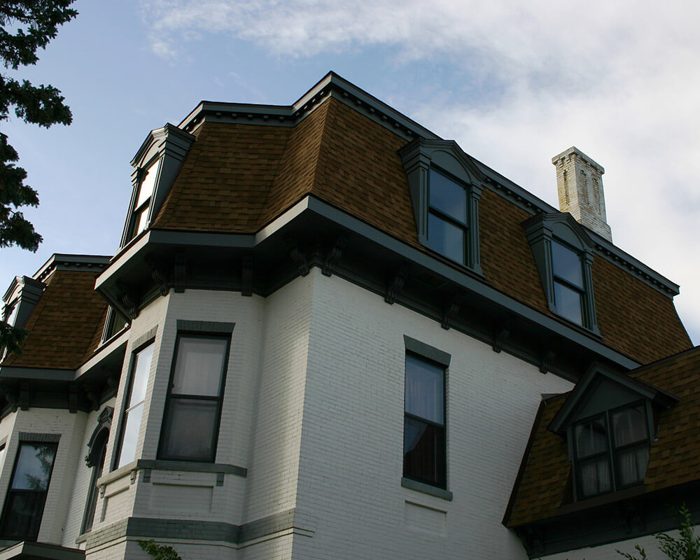 After the Historic Preservation, Exterior Remodel, and restored Dormers were added to this 1880’s Second Empire Victorian home by TDS Custom Construction.